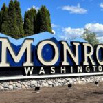 Municipal outdoor monument sign with stone base.