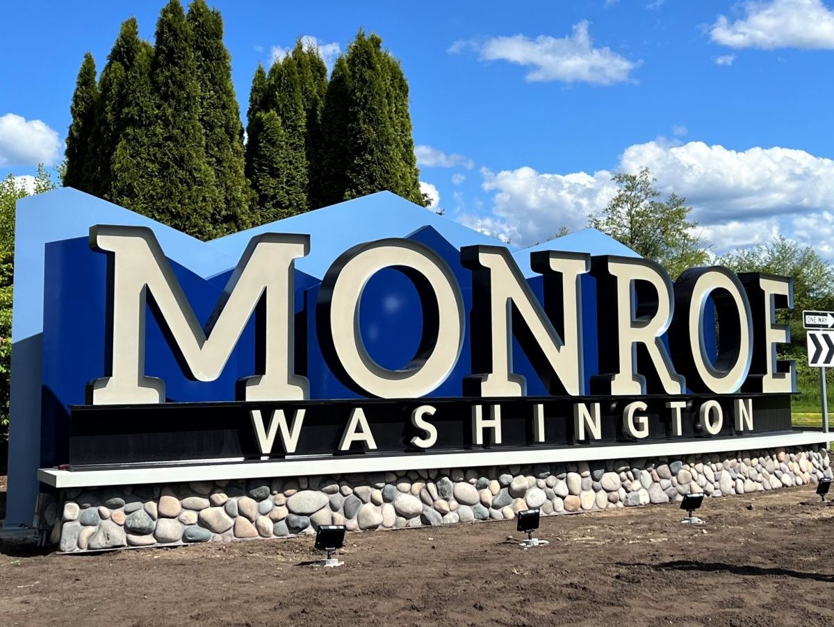 Municipal outdoor monument sign with stone base.