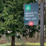 Airport direction sign with arrow.