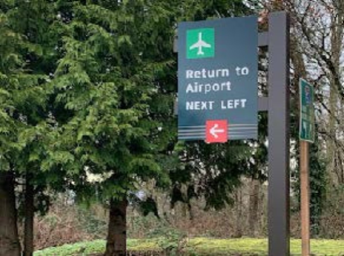 Airport direction sign with arrow.